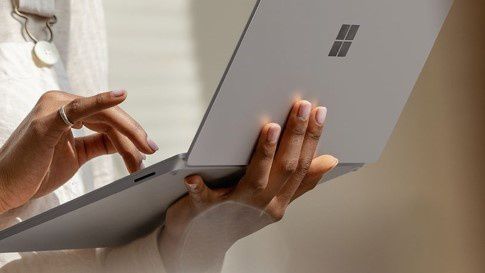 A woman types on Surface Laptop 3