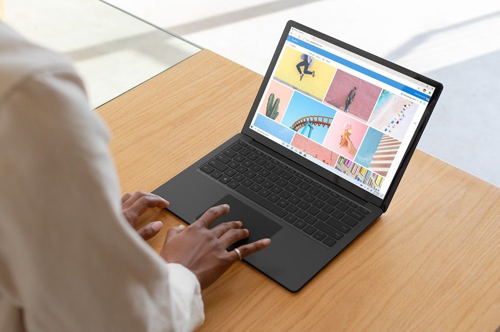 A woman types on Surface Laptop 3
