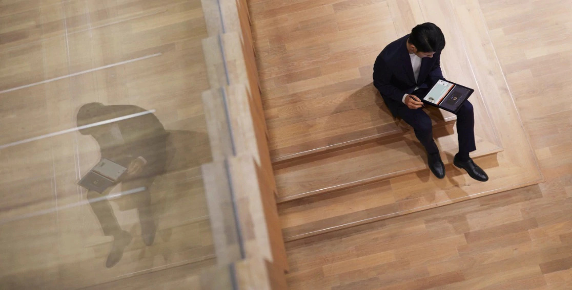 Overhead shot of Lenovo ThinkPad X1 Fold in use on a man's lap.